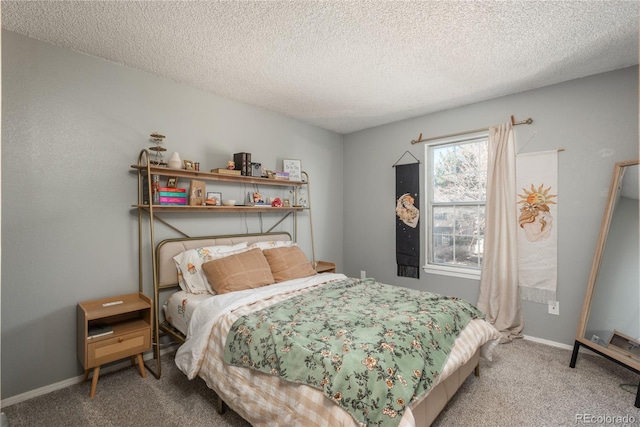 bedroom with carpet flooring, baseboards, and a textured ceiling