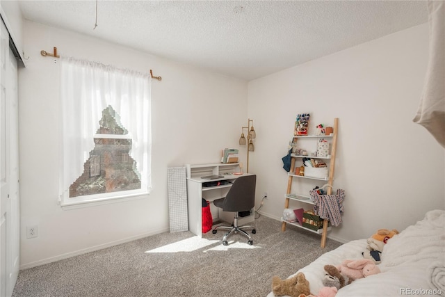 carpeted office space with baseboards and a textured ceiling