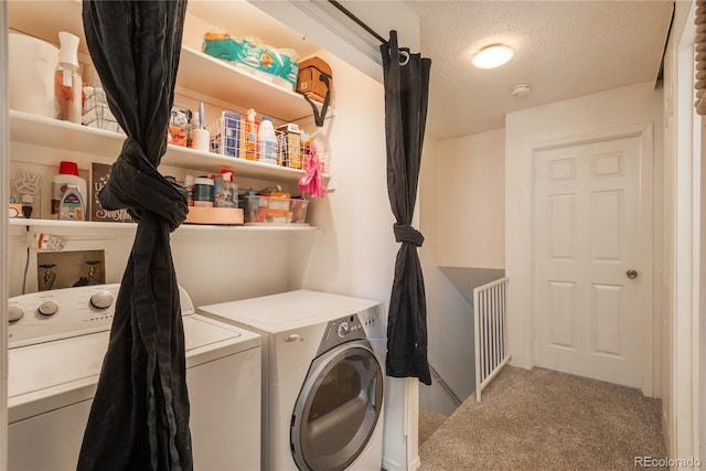 clothes washing area with laundry area, washing machine and dryer, a textured ceiling, and carpet floors