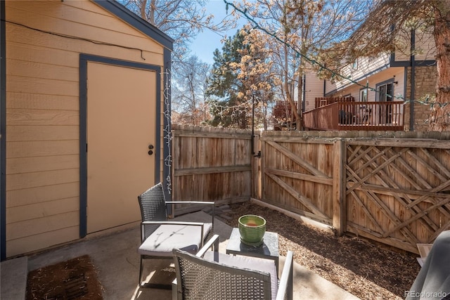 view of patio with fence and a gate