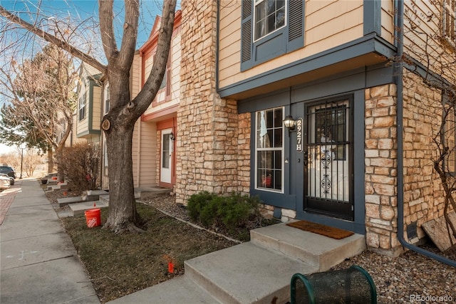 view of exterior entry with stone siding