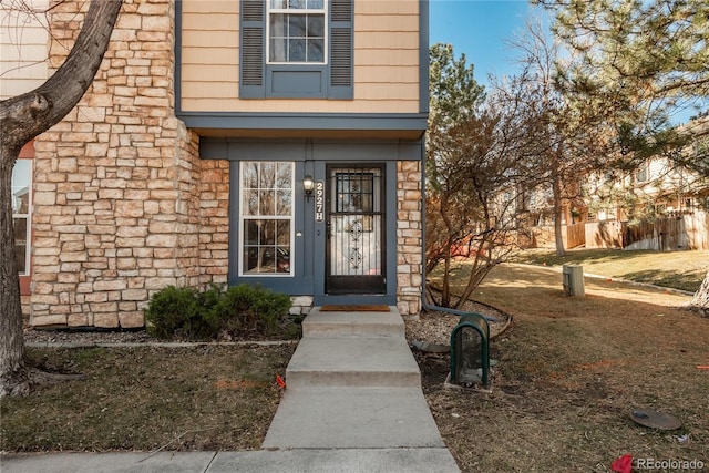 property entrance featuring stone siding