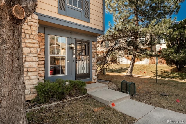 view of exterior entry with stone siding