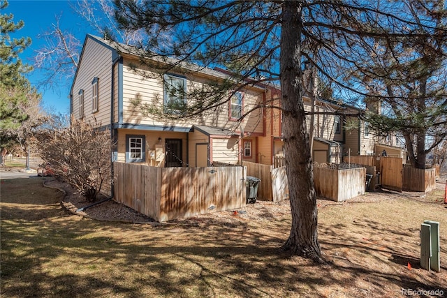 view of side of home featuring fence