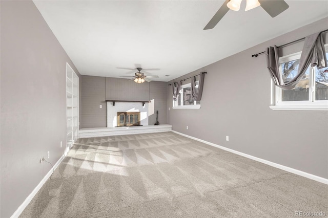 unfurnished living room featuring light carpet, a healthy amount of sunlight, and ceiling fan