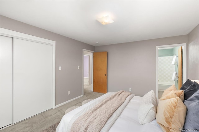 carpeted bedroom featuring a closet and connected bathroom