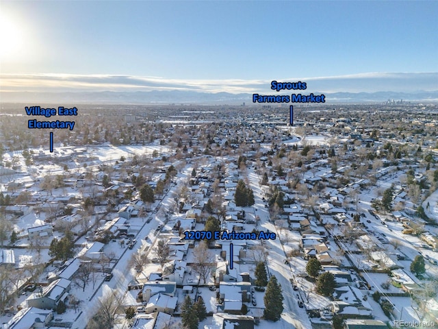 snowy aerial view with a mountain view