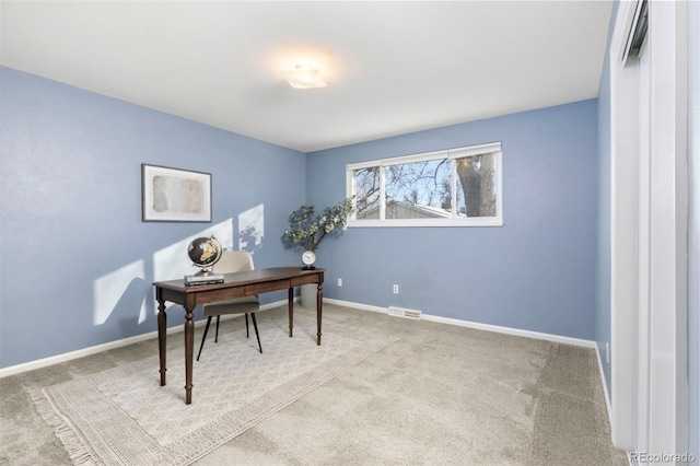 office space with carpet floors, visible vents, and baseboards