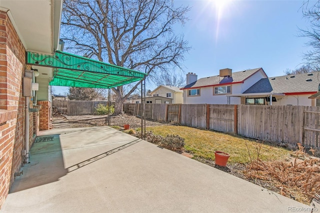 view of patio featuring a fenced backyard and a residential view