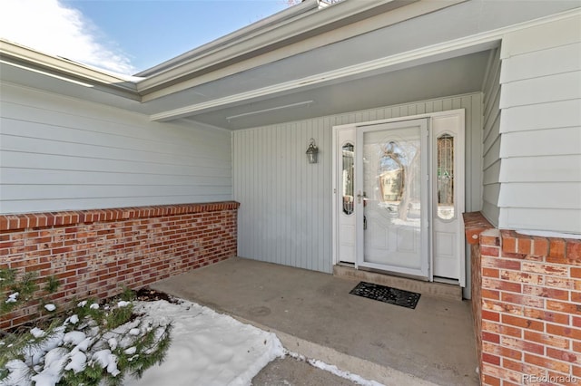 property entrance with brick siding