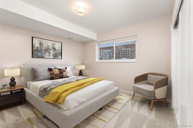 bedroom featuring light carpet, visible vents, and baseboards