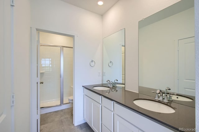14578 W 90th Ln Unit B, Arvada, CO 80005 - bathroom with a shower stall, double vanity, and tile patterned flooring