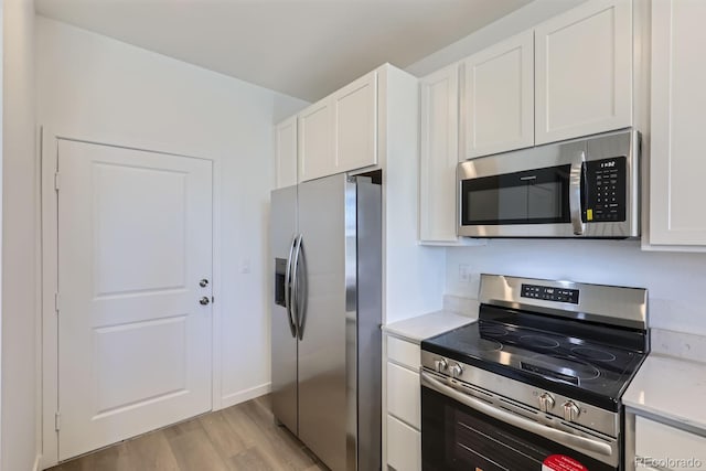742 N Bently St, Watkins, CO 80137 - kitchen featuring appliances with stainless steel finishes, light wood-style floors, white cabinetry, and light stone counters