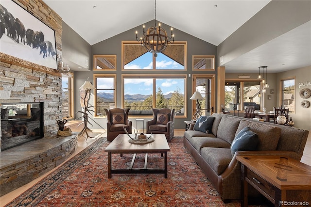 15077 Wilson Peak Rd, Pine, CO 80470 - living room with a chandelier, wood finished floors, a mountain view, a fireplace, and high vaulted ceiling