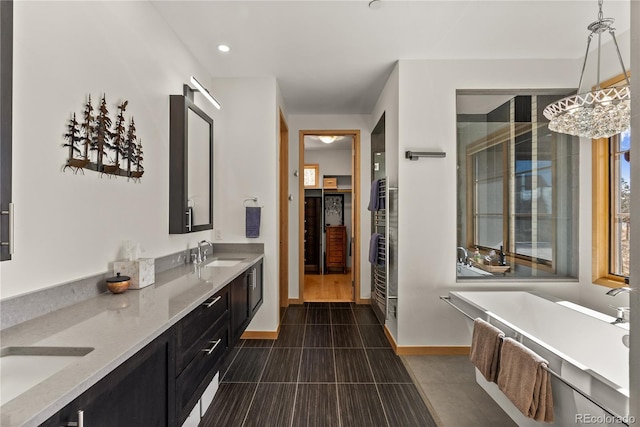 15077 Wilson Peak Rd, Pine, CO 80470 - full bath featuring a freestanding tub, double vanity, tile patterned floors, recessed lighting, and a towel warming rack