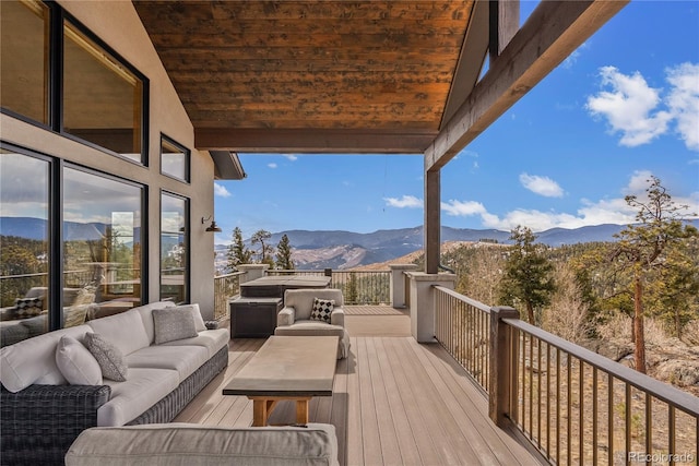 15077 Wilson Peak Rd, Pine, CO 80470 - wooden deck with an outdoor hangout area and a mountain view