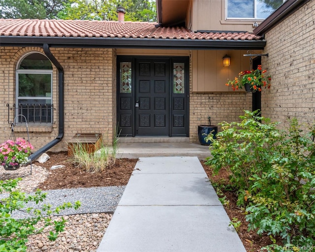 8793 E Monmouth Pl, Denver, CO 80237 - entrance to property featuring brick siding, a porch, and board and batten siding