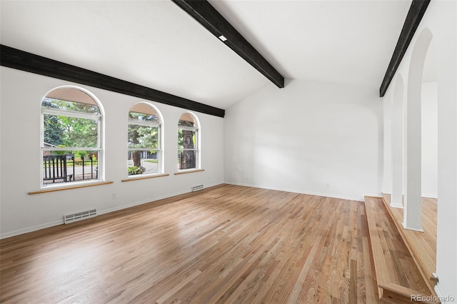 8793 E Monmouth Pl, Denver, CO 80237 - unfurnished living room featuring light wood-style floors, arched walkways, and baseboards