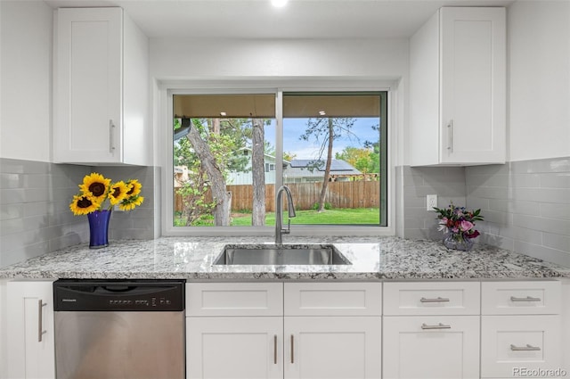8793 E Monmouth Pl, Denver, CO 80237 - kitchen featuring dishwasher, a sink, tasteful backsplash, and white cabinetry
