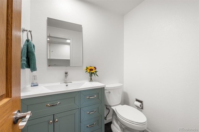 8793 E Monmouth Pl, Denver, CO 80237 - bathroom featuring toilet, vanity, and baseboards