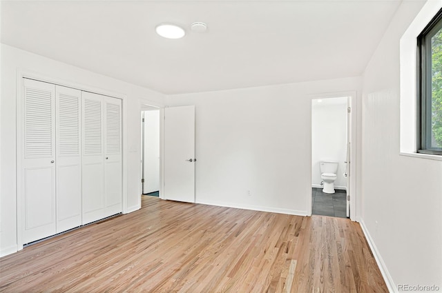 8793 E Monmouth Pl, Denver, CO 80237 - unfurnished bedroom featuring light wood-style floors, ensuite bathroom, a closet, and baseboards