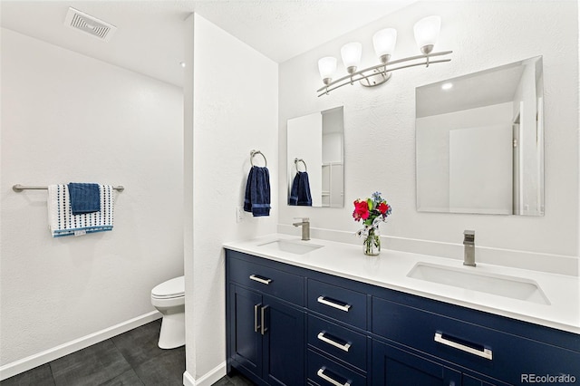 8793 E Monmouth Pl, Denver, CO 80237 - bathroom with toilet, baseboards, and double vanity