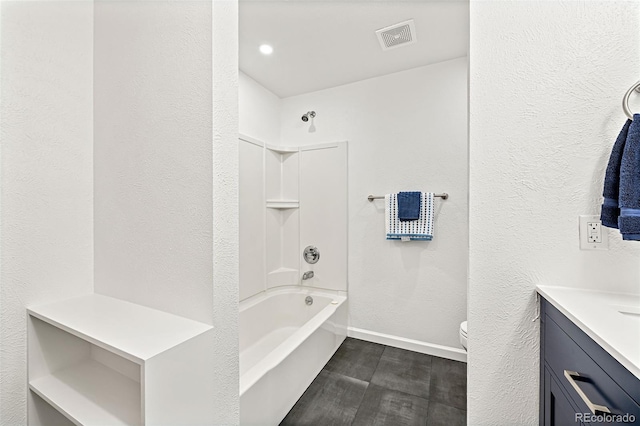 8793 E Monmouth Pl, Denver, CO 80237 - bathroom with wood finished floors, toilet, vanity, baseboards, and bathtub / shower combination