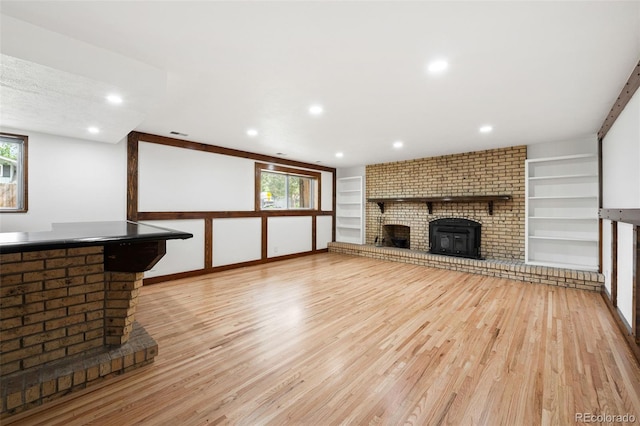 8793 E Monmouth Pl, Denver, CO 80237 - unfurnished living room with light wood finished floors, a fireplace, built in shelves, and recessed lighting