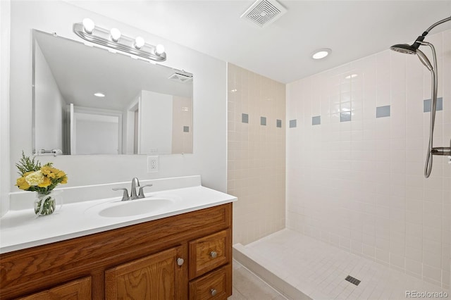 8793 E Monmouth Pl, Denver, CO 80237 - full bathroom featuring a tile shower, vanity, recessed lighting, and tile patterned floors