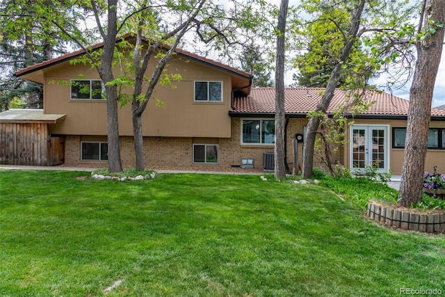8793 E Monmouth Pl, Denver, CO 80237 - back of property featuring french doors, a lawn, brick siding, and central air condition unit