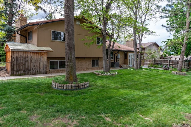 8793 E Monmouth Pl, Denver, CO 80237 - back of property featuring a chimney and brick siding