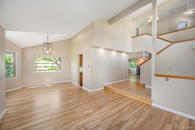 7582 Powderhorn Dr, Lone Tree, CO 80124 - unfurnished room featuring lofted ceiling, a chandelier, light wood-type flooring, baseboards, and stairway