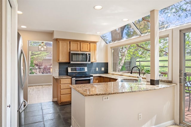 7582 Powderhorn Dr, Lone Tree, CO 80124 - kitchen featuring appliances with stainless steel finishes, a sink, recessed lighting, tasteful backsplash, and light stone counters