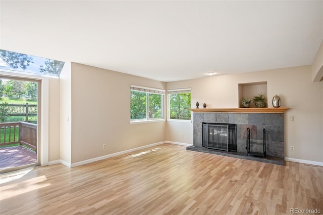 7582 Powderhorn Dr, Lone Tree, CO 80124 - unfurnished living room with a fireplace, wood finished floors, and baseboards
