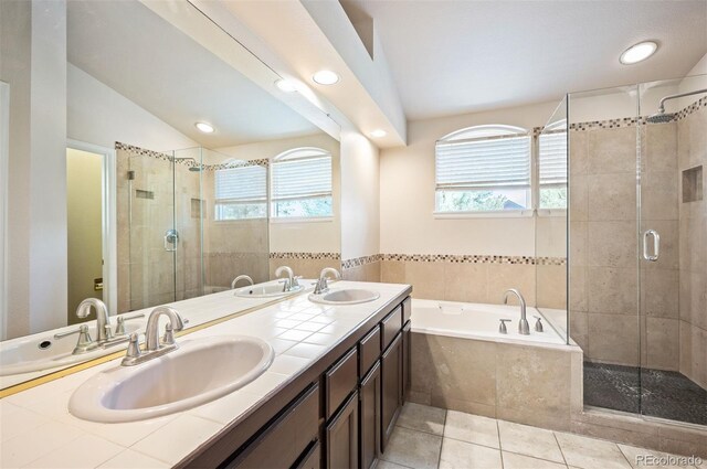 7582 Powderhorn Dr, Lone Tree, CO 80124 - full bathroom with a garden tub, a stall shower, double vanity, tile patterned floors, and recessed lighting