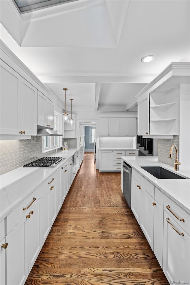 kitchen featuring white cabinetry, appliances with stainless steel finishes, open shelves, and a sink