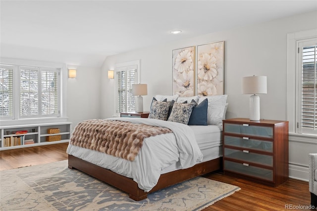 bedroom with lofted ceiling, wood finished floors, and recessed lighting