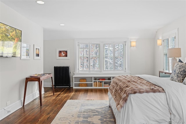 bedroom with radiator, wood-type flooring, baseboards, and recessed lighting