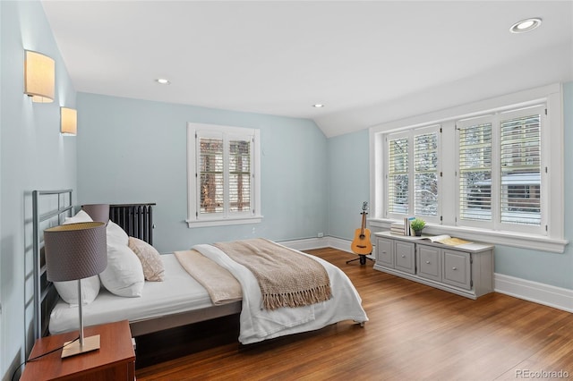 bedroom featuring vaulted ceiling, wood finished floors, and baseboards