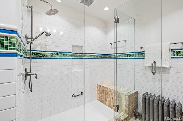 bathroom with radiator heating unit, visible vents, and a stall shower