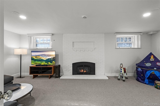 carpeted living area with recessed lighting, a brick fireplace, and baseboards