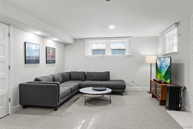 living room featuring light carpet, baseboards, and recessed lighting