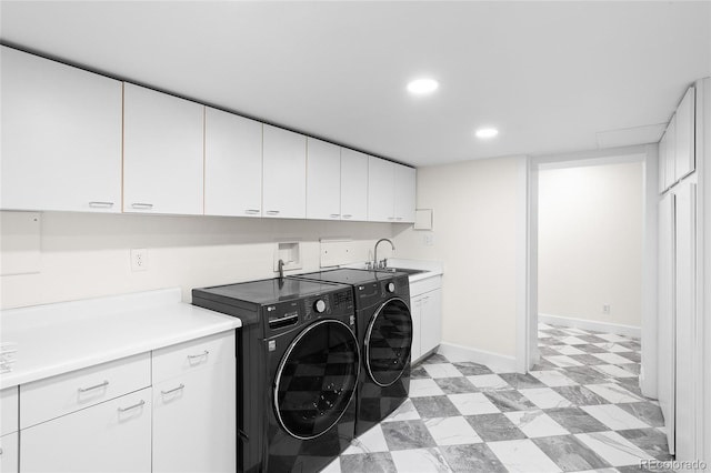 laundry room with light floors, recessed lighting, cabinet space, a sink, and separate washer and dryer