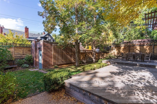 view of yard featuring fence and a deck