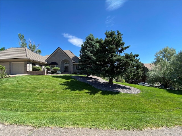 view of front of house featuring a garage and a front lawn