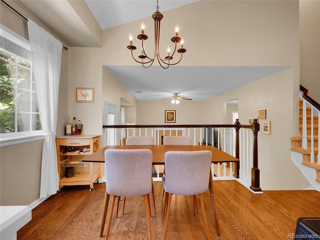 1234 Riddlewood Ln, Highlands Ranch, CO 80129 - dining area with a chandelier, a ceiling fan, wood finished floors, stairway, and lofted ceiling