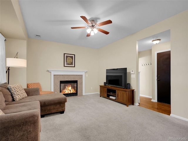 1234 Riddlewood Ln, Highlands Ranch, CO 80129 - living area featuring a tile fireplace, carpet flooring, and a ceiling fan