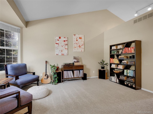 1234 Riddlewood Ln, Highlands Ranch, CO 80129 - living area featuring lofted ceiling, carpet floors, and rail lighting