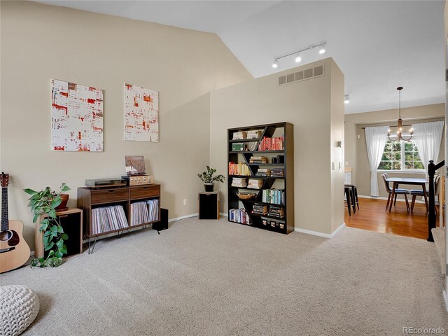 1234 Riddlewood Ln, Highlands Ranch, CO 80129 - living area with carpet, lofted ceiling, a chandelier, and rail lighting