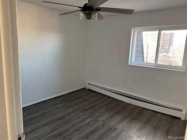 empty room featuring a baseboard heating unit, ceiling fan, and dark wood-style floors